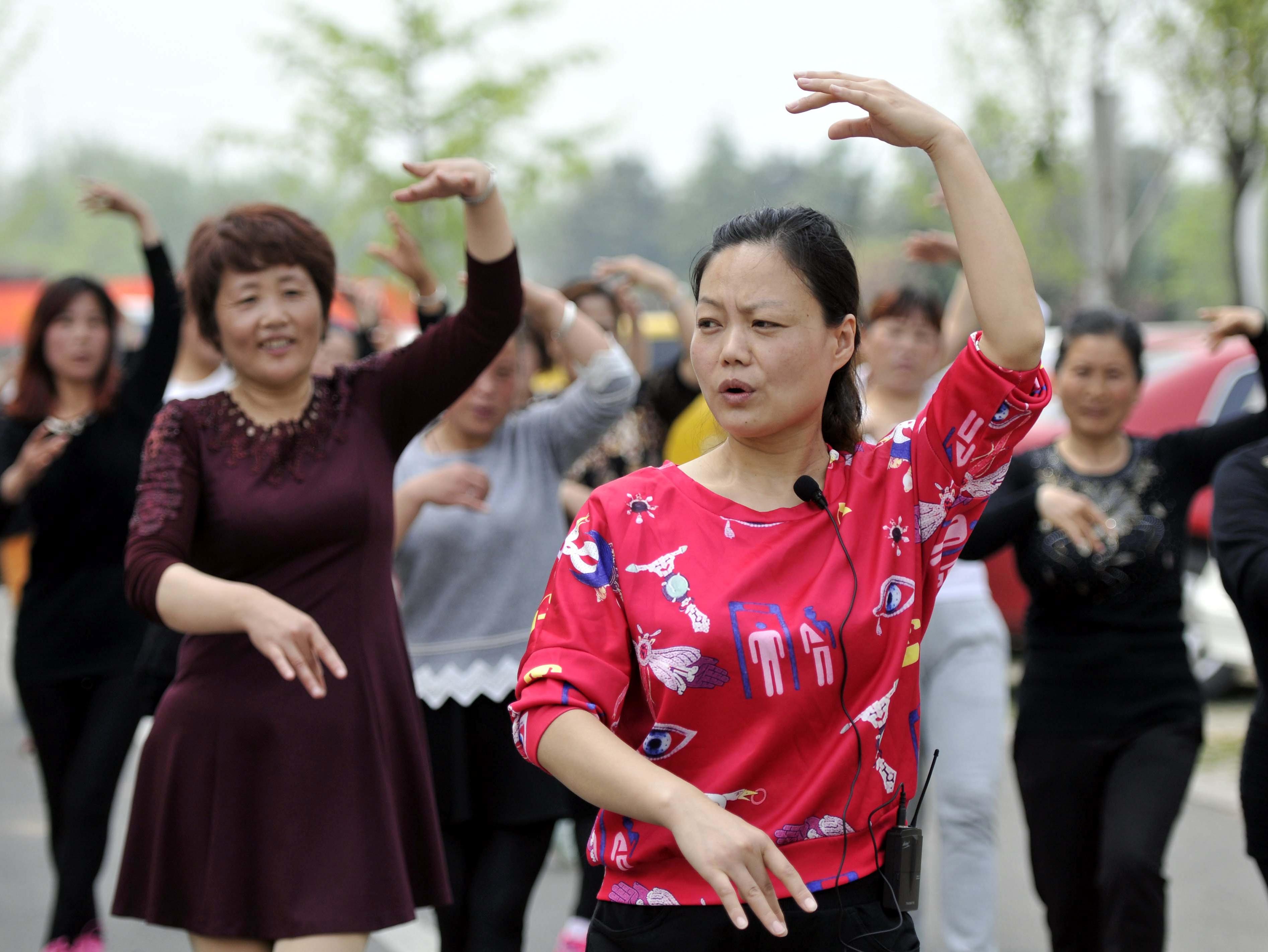 舞蹈老师董红梅(前)在传授新编广场舞的基本动作