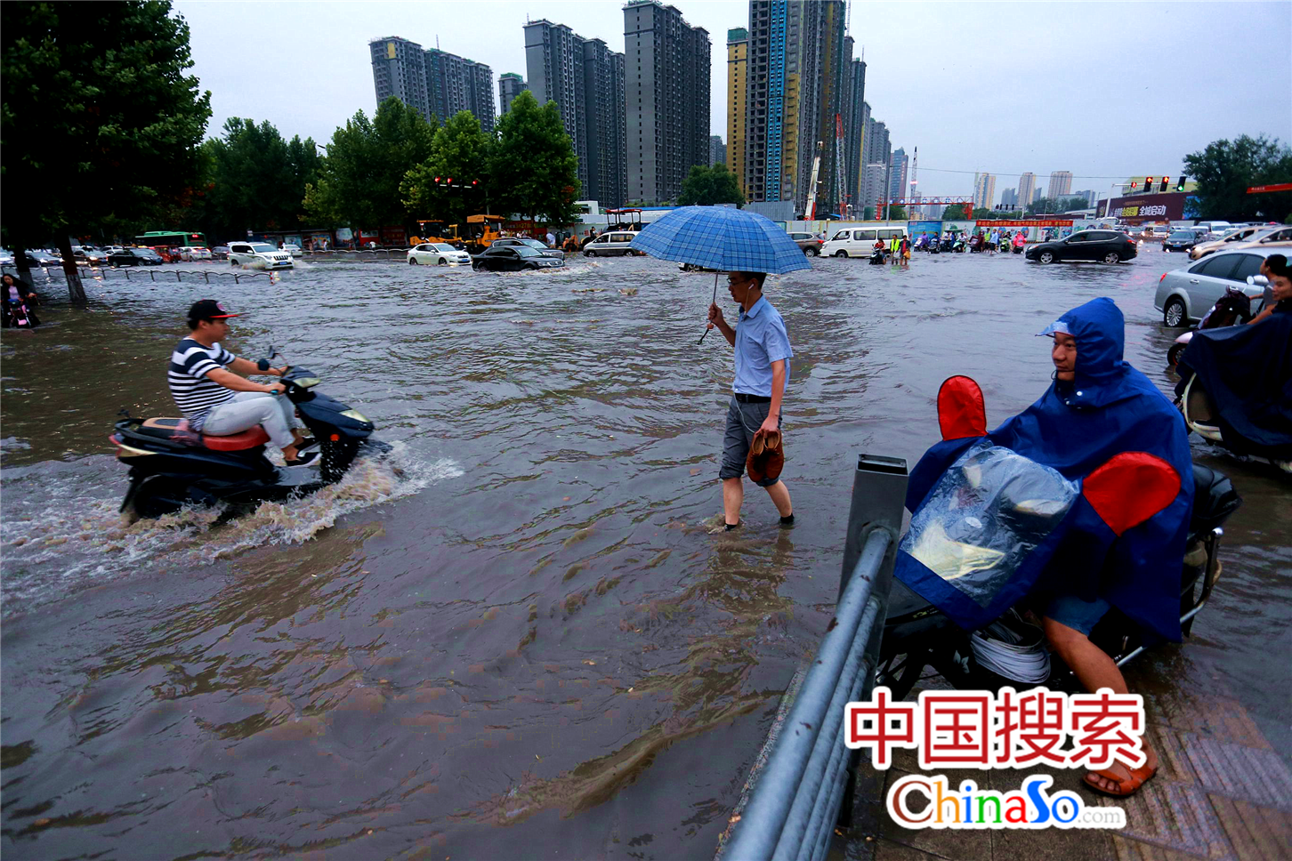 郑州暴雨积水成河 交警水中赤脚执勤